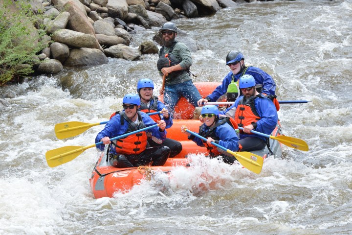 a group of people on a raft in the water